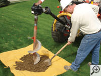 Auguring a hole in the earth for a foundation repair in Jackson