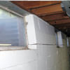 A foundation showing severe inward buckling along the windows in a Lucasville home.