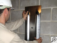 Mounting a foundation wall plate for an earth anchor installation in Hurricane.