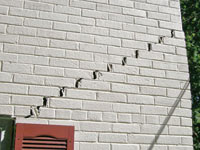 Stair-step cracks showing in a home foundation in Barboursville