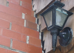 A tilting chimney in South Point showing serious foundation damage.