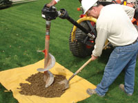 Auguring a hole in the earth for a foundation wall repair system in Pikeville
