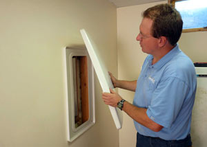 Foundation wall anchor covers installed in a finished basement with a repaired foundation wall in Catlettsburg.