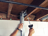 Straightening a foundation wall with the PowerBrace™ i-beam system in a Ironton home.