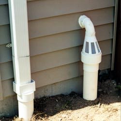 A grated sump pump discharge line fitting in Barboursville