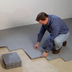 basement subfloor tiles being installed by a contractor in Belpre