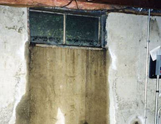 Water pouring out from a basement window in Athens